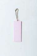 A light pink rectangular Christian acrylic keychain/charm with embossed text – Bible verse 1 Corinthians 13:4-5, attached to a silver ball chain, shown against a plain white background.